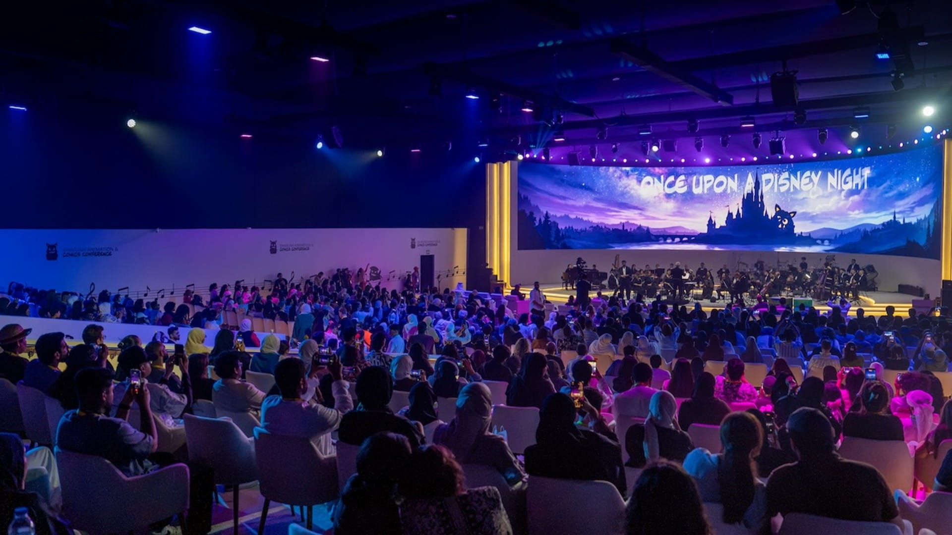 A large crowd of visitors and creative professionals attending an animation and comics exhibition at a modern venue in